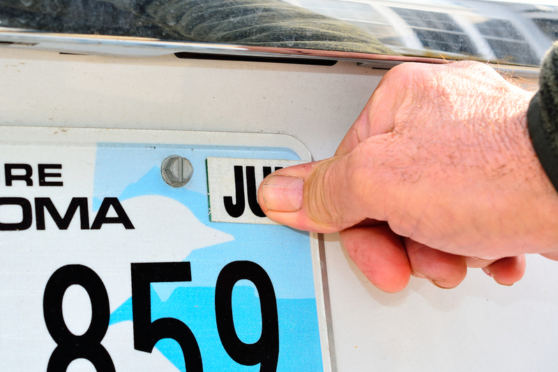 Use Dampened Newspaper to Remove Old Registration Stickers | Shutterstock